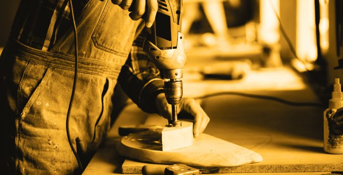 The carpenter works with a tree